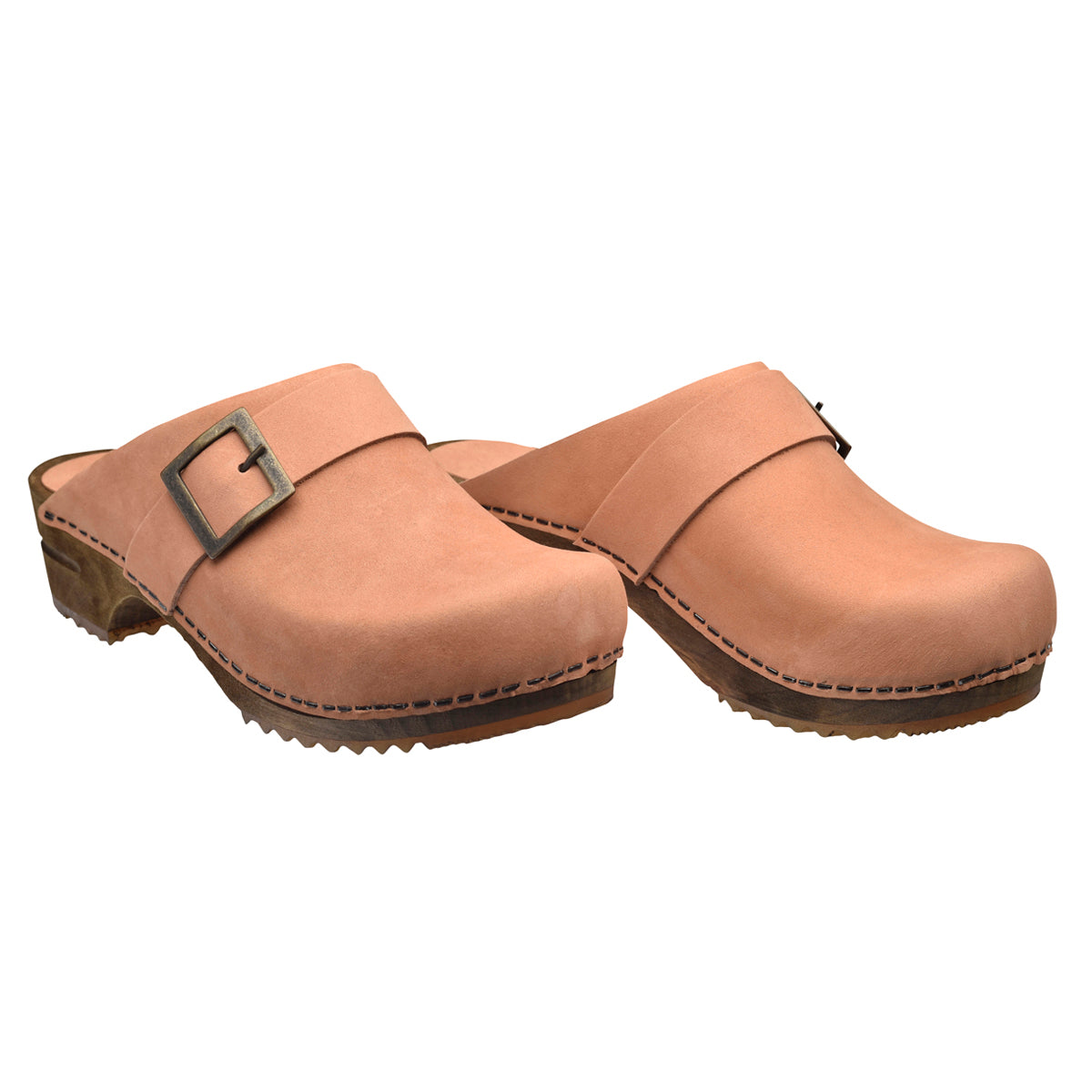 Salmon pink beige clog with large decorative buckle on white background and wooden soles.