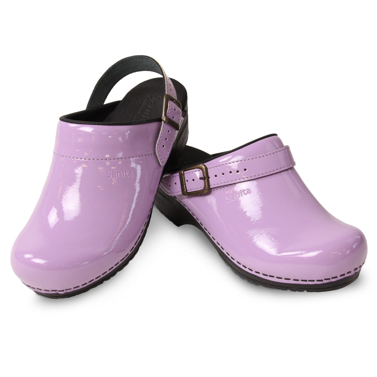 Lilac colored clogs on white background.